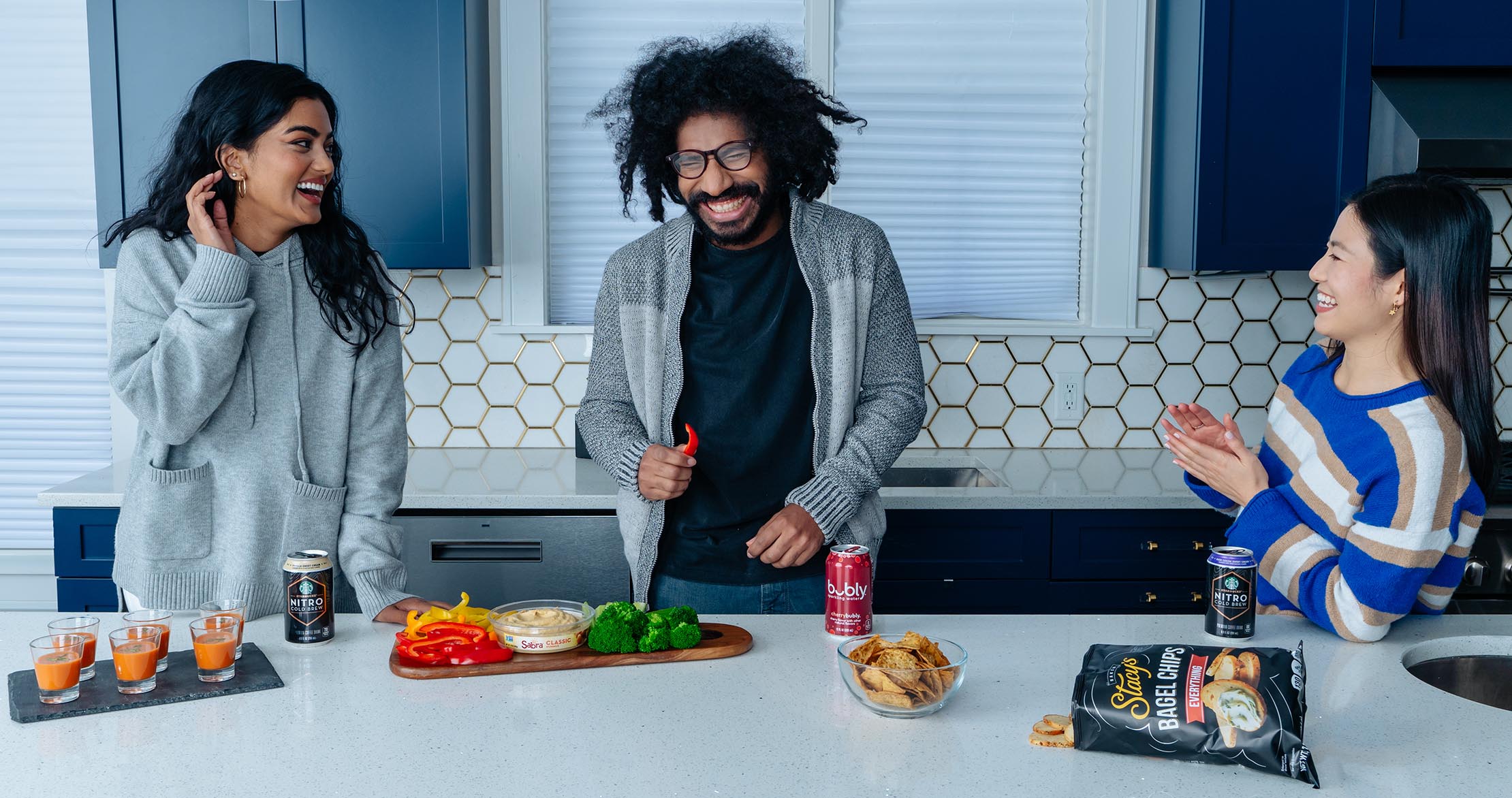 friends sharing a plate of veggies and humus