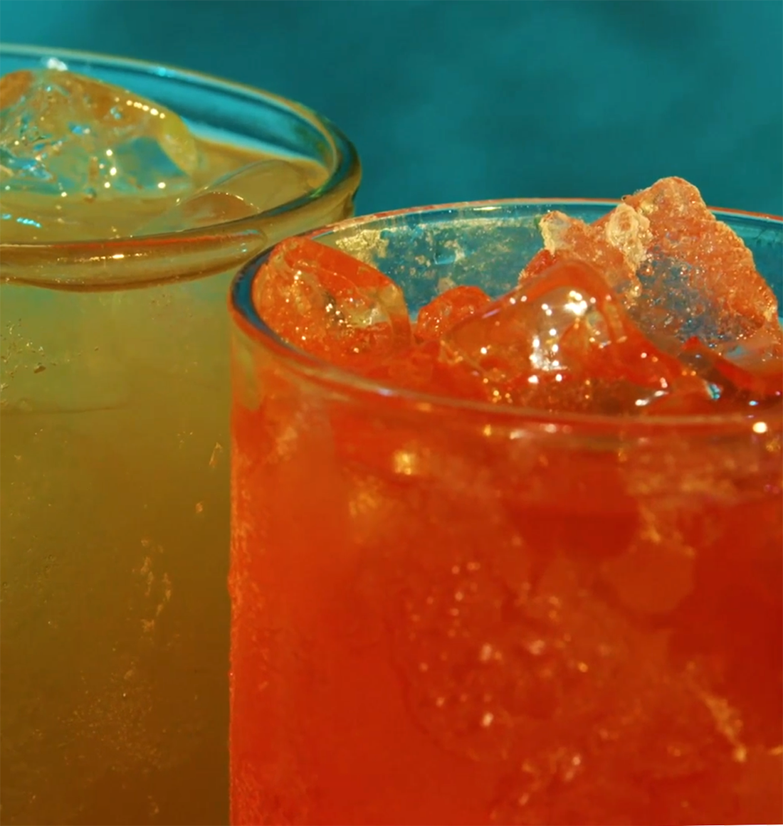 Two brightly colored carbonated drinks